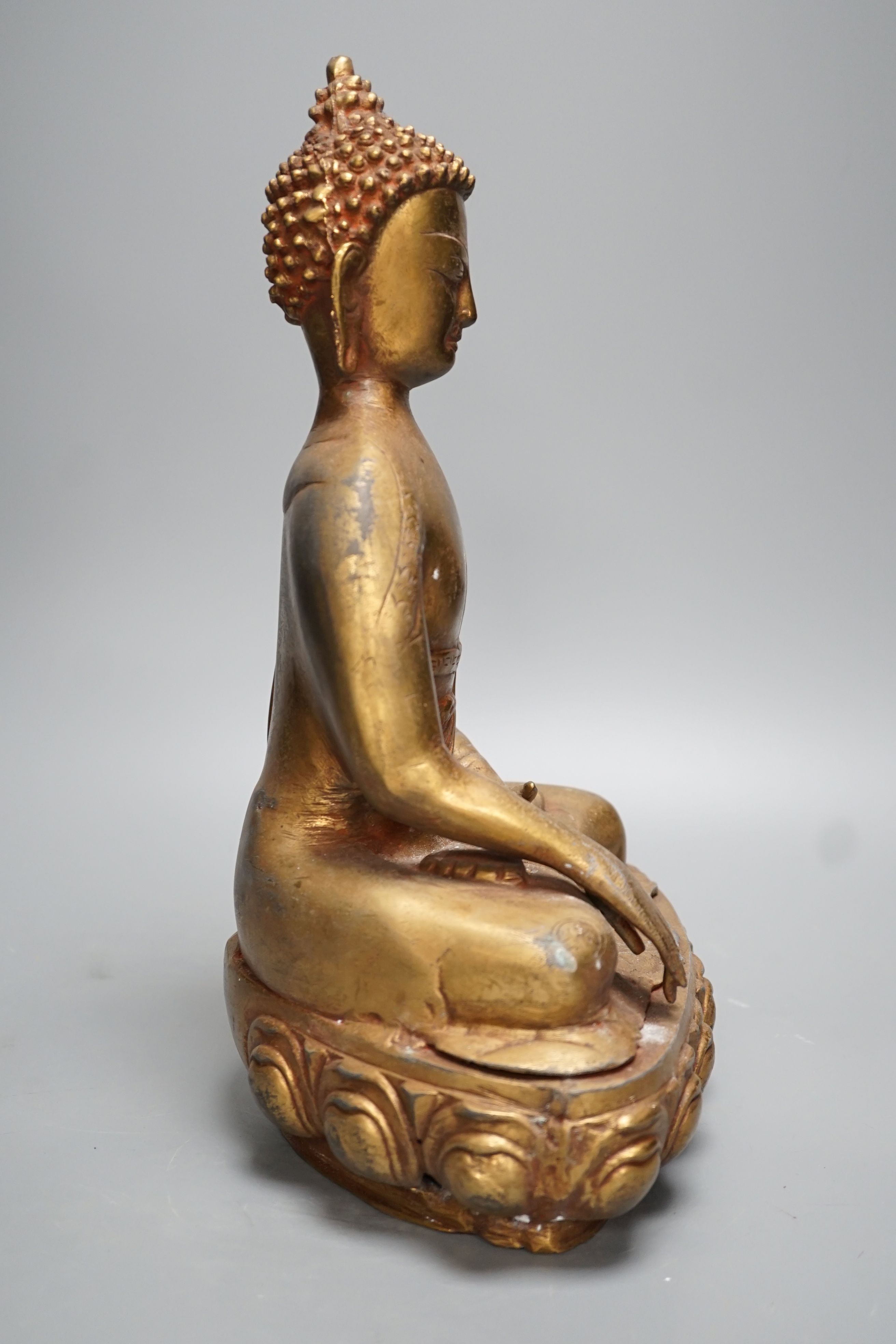 A gilt brass seated figure of Buddha - 38cm high